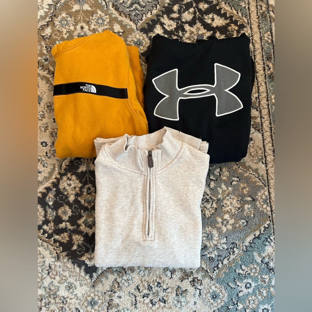 Bundle of the North Face hoodie, Under Armour hoodie, and half sip George.